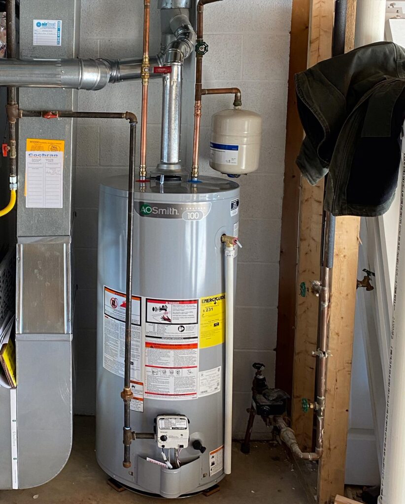 AO Smith Water Heater Installation – High-Efficiency Residential Unit. AO Smith high-efficiency water heater installed in a residential utility room, ensuring reliable hot water with improved energy efficiency.